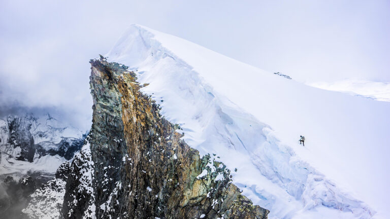 Kilian Jornet climbing up a mountain 